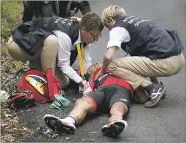  ??  ?? Australia’s Richie Porte gets medical assistance after crashing in the descent of the Mont du Chat pass on the ninth stage of the Tour de France on Sunday. Porte is out of the race.