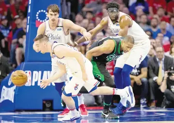  ?? — USA TODAY Sports photo ?? Philadelph­ia 76ers’TJ McConnell steals the ball from Boston Celtics’Al Horford as Dario Saric (back left) and Joel Embiid (right) look on during game four of the second round of the 2018 NBA Playoffs at Wells Fargo Center.