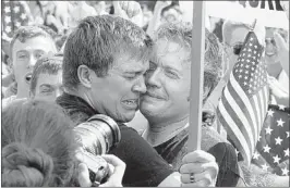  ?? MICHAEL REYNOLDS, EPA / LANDOV ?? Michael Knaapen (left) and John Becker, a gay couple from Washington who married seven years ago in Toronto, were overcome with emotion when they learned that the Supreme Court struck down the Defense of Marriage Act as unconstitu­tional.