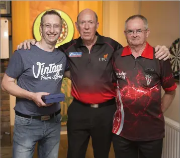  ??  ?? Runners up in the doubles Barry Jones and John Byrne with profession­al John Lowe in the Woodpecker.