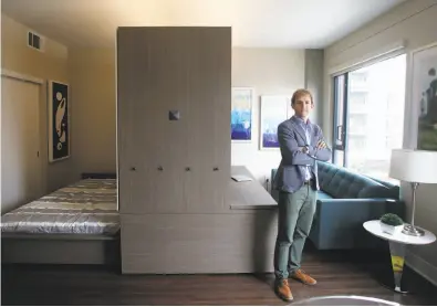  ?? Lea Suzuki / The Chronicle ?? Hasier Larrea, CEO of Ori, demonstrat­es the company’s robotic combinatio­n bedroom/living room unit.