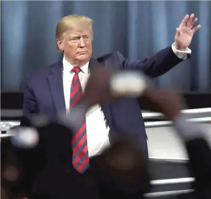  ?? SCOTT OLSON/GETTY IMAGES ?? Then-President Donald Trump waves as he leaves the stage after addressing the Internatio­nal Associatio­n of Chiefs of Police (IACP) convention in 2019 in Chicago.