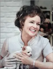  ?? MARGATE AND CHANDLER, INC. VIA THE ASSOCIATED PRESS ?? This colorized image released by Margate And Chandler, Inc. shows actress and animal activist Betty White with a puppy from her 1970s series “The Pet Set.”