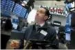  ?? RICHARD DREW — THE ASSOCIATED PRESS ?? Trader Tommy Kalikas works on the floor of the New York Stock Exchange on Monday.