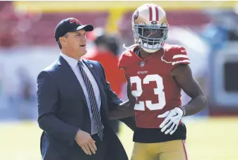  ?? Jason Behnken / Associated Press ?? General manager John Lynch greets cornerback Ahkello Witherspoo­n before the 49ers played in Tampa, Fla., on Nov. 25. Witherspoo­n, a ’17 third-round pick, was benched twice this season.