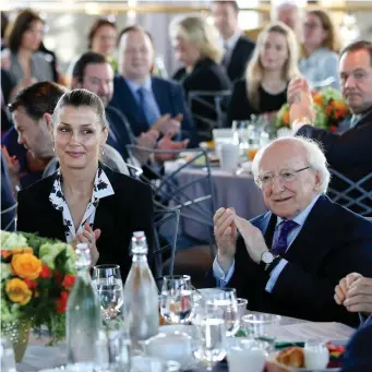  ??  ?? President Michael D Higgins is joined by Bridget Moynahan – an American actress and model who stars in the television series ‘Blue Bloods’ – at the Ireland Funds breakfast event held yesterday in the Rockefelle­r Centre in New York Photo: Maxwells