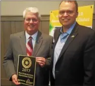  ?? BILL RETTEW JR. - DIGITAL FIRST MEDIA ?? BID Executive Director Malcolm Johnstone, left, shows off a national award with Mayor Jordan Norley.