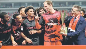  ??  ?? Arsenal’s Petr Cech (second right) with teammates celebrate with the trophy after the Internatio­nal Champions Cup match against German champions Bayern Munich in Shanghai. — Reuters photo