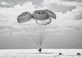  ?? SpaceX via Associated Press ?? A capsule carrying the first all-amateur crew to circle the world without a profession­al parachutes Saturday into the Atlantic Ocean off the Florida coast.