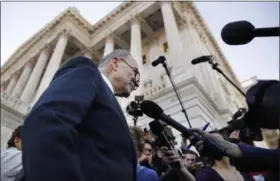  ?? JACQUELYN MARTIN — THE ASSOCIATED PRESS ?? Senate Minority Leader Chuck Schumer, D-N.Y., center, speaks to the media outside the Capitol after meeting with President Donald Trump in Washington. On Friday The Associated Press has found that stories circulatin­g on the internet about Schumer...