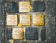  ??  ?? So called stumbling blocks, marking the last voluntaril­y chosen places of residence of the victims of the Nazis, are embedded in the pavement in Berlin, Germany.