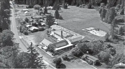  ?? AP ?? This undated aerial photo taken from a drone video and provided by LandandWil­dlife.com shows Tiller, Ore. Almost all of the downtown in Tiller, a dying timber town in remote southweste­rn Oregon, is for sale for $3.5 million. The elementary school is...
