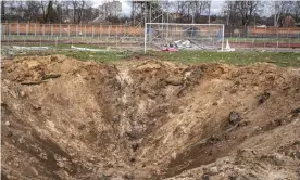  ?? ?? A huge crater on the pitch at the FC Desna stadium in Chernihiv. Photograph: Lorenzo Ambrosino