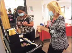  ?? ?? Wright Tech School staff psychologi­st Laurie Eagan, right, gets a cup of coffee at The Wright Bean.