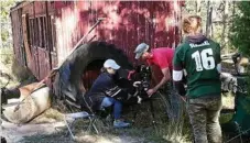  ??  ?? Adjusting equipment are (from left) camera operator Millie Rowley and director of photograph­y Damian Hussey, as Jesse Schmerl stands.