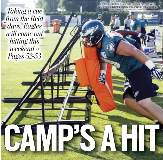  ?? CHRIS SZAGOLA — THE ASSOCIATED PRESS ?? Eagles guard Isaac Seumalo pushes the sled with teammates during practice this week in Philadelph­ia.