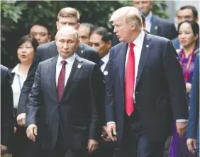  ?? FILE PHOTO BY JORGE SILVA/POOL PHOTO VIA AP ?? President Donald Trump, right, and Russia’s President Vladimir Putin talk during the family photo session at the APEC Summit in Danang, Vietnam, on Nov. 11.