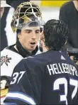  ?? David Lipnowski/Getty Images ?? Marc-Andre Fleury shakes hands with Winnipeg’s Connor Hellebuyck after the Vegas Golden Knights won the Western Conference final Sunday.