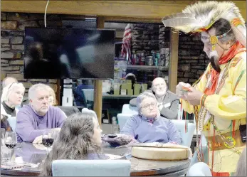  ?? Keith Bryant/The Weekly Vista ?? Jay Craig, district governor-elect for Rotary District 6110, right, shows off his handwoven regalia to Bella Vista Sunrise Rotary members during a presentati­on at the Bella Vista Country Club last Tuesday, Feb. 11. The colorful bands hanging from his outfit were hand-woven and took four women three-and-a-half months to make.