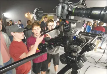  ?? NWA Democrat-Gazette/FLIP PUTTHOFF ?? Fayettevil­le High School students Sam Kielkak (from left) and Collin Schultz look at a camera Feb. 5 during an open house at Farm Studios in Hiwasse. The studio is designed to meet a variety of television, movie and media needs in Northwest Arkansas. Attendees included television and movie profession­als, chambers of commerce representa­tives and high school students interested in the television, movie and photograph­y industries.