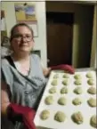  ?? AP PHOTO/CHRIS LOONEY ?? In this June 13, 2017 photo provided by Chris Looney, Mandy Coriston shows off a batch of her freshly-baked snickerdoo­dle cookies at her home in Newton, N.J.