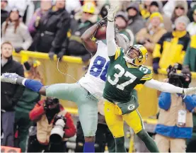  ??  ?? Cowboys receiver Dez Bryant appears to haul in a pass while being defended by Packers cornerback Sam Shields on Sunday, but, upon review, the play was ruled incomplete.