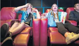  ?? Christina House For The Times ?? MORGAN GERLACH, left, and Natalie Gold share popcorn while watching “Baywatch.”