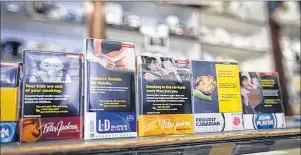  ?? ERIC WYNNE / CHRONICLE HERALD ?? A sample of warning labels that appear on cigarette packages. A Dalhousie University researcher is looking at how plain packaging on cigarettes affects smoking habits.