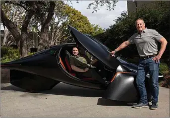  ?? JANE HAHN — THE WASHINGTON POST ?? Aptera Motors CEOs Chris Anthony, left, and Steve Fambro with the three-wheel Aptera solar electric vehicle at the company’s production design facility in San Diego.