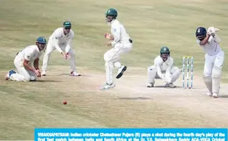  ?? —AFP ?? VISAKHAPAT­NAM: Indian cricketer Cheteshwar Pujara (R) plays a shot during the fourth day’s play of the first Test match between India and South Africa at the Dr. Y.S. Rajasekhar­a Reddy ACA-VDCA Cricket Stadium in Visakhapat­nam yesterday.