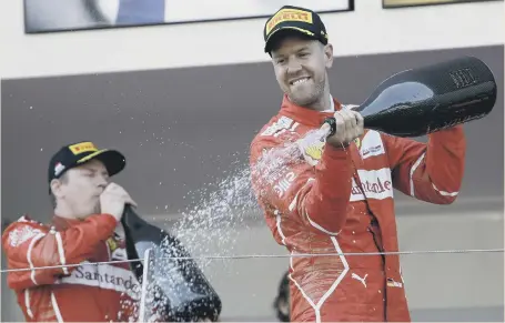  ??  ?? Sebastian Vettel celebrates his Monaco Grand Prix success with Ferrari team-mate Kimi Raikkonen.