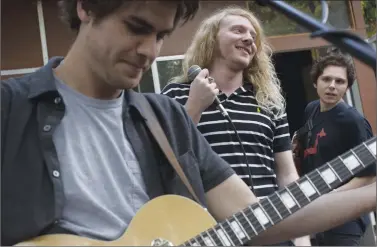  ?? Photos by Karla Gachet/The Washington Post ?? Above, from left, Matt O'Keefe, Mario Cuomo and Dominic Corso of The Orwells, perform during a house party hosted on Saturday in Los Angeles. Below, one of The Orwells' manager, Jack Steven, checks out the house party.