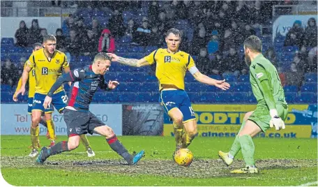  ??  ?? Billy Mckay scores the home side’s dramatic equaliser in atrocious conditions at Victoria Park