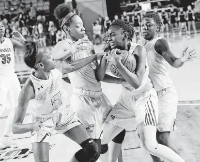  ?? [PHOTO BY NATE BILLINGS, THE OKLAHOMAN] ?? Owasso’s Terryn Milton, front, tries to keep the ball away from Putnam City West’s Alyssa Boyce, left, Zaniya Nelson and Sharonica Hartsfield, right, during Saturday’s state championsh­ip game.