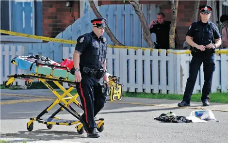  ?? SUPPLIED ?? Police investigat­e the scene of a fatal hit-and-run outside a townhouse complex near 116A Avenue and 29th Street on Friday.