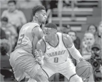  ?? AP Photo/Nell Redmond ?? ■ Oklahoma City Thunder guard Russell Westbrook, right, drives against Charlotte Hornets guard Jeremy Lamb during the first half Thursday in Charlotte, N.C.