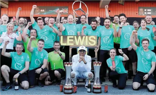  ??  ?? MONTMELO: Mercedes’ British driver Lewis Hamilton (C) poses with his team after winning the Spanish Formula One Grand Prix on May 14, 2017 at the Circuit de Catalunya. —AFP