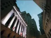  ?? MARK LENNIHAN — THE ASSOCIATED PRESS FILE ?? American flags fly in front of the New York Stock Exchange.