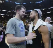  ?? ?? Mavericks guard Luka Doncic, left, talks with Warriors guard Stephen Curry following Thursday night’s Game 5 of the Western Conference finals in San Francisco.