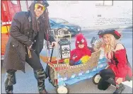  ?? Westside Eagle Observer/SUSAN HOLLAND ?? Steven and Amy Woolsey, of Rogers, dressed as pirates, pose with their daughter Willow, dressed as a parrot.