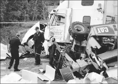  ?? — Photo by Gary Kean/the Western Star ?? Members of the RNC and Corner Brook Fire Department investigat­e a transport truck accident Friday afternoon.