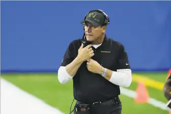  ?? Duane Burleson / Associated Press ?? Washington Football Team head coach Ron Rivera watches during his team’s loss to the Lions on Nov. 15. After starting his first season 27, Washington has won three straight.