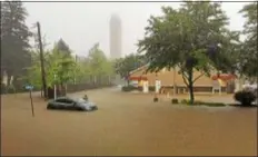  ?? SUBMITTED PHOTO ?? A car sits in flood waters after torrential rains left Banbury Way and Francis Avenue under water Monday morning.