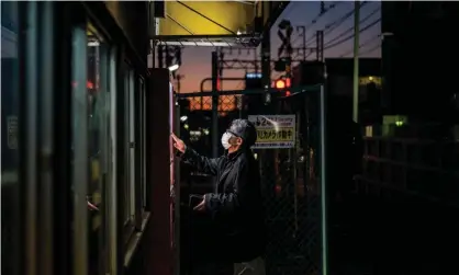  ?? ?? A man buys a drink from a vending machine in Tokyo. Photograph: Philip Fong/AFP/Getty Images