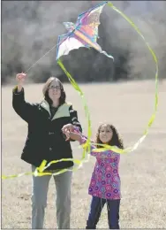  ?? FILE PHOTO ?? Julie Moore of Prairie Grove helps her daughter, Addison Moore, fly a kite during the 14th annual Cane Hill Kite Festival last year.