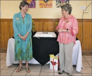  ?? The Sentinel-Record/Mara Kuhn ?? BEST WISHES: Pati Trippel, right, vice chair of the board of directors for Ouachita Children’s Center, speaks as Linda Ragsdale, retiring executive director of OCC, looks on during her retirement party Friday which doubled as the 40th birthday...