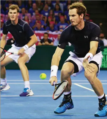  ??  ?? IN SyNC: brothers Andy (right) and Jamie Murray find their winning rhythm in a tense match in Glasgow