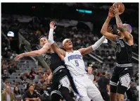  ?? (AP photo/Darren Abate) ?? Orlando Magic’s Paolo Banchero (5) tangles with San Antonio Spurs’ Jeremy Sochan (10) and Zach Collins under the basket Tuesday during the first half of a basketball game in San Antonio.