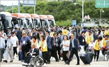  ?? THE ASSOCIATED PRESS ?? South Koreans leave for North Korea to take part in family reunions with their North Korean family members at the customs, immigratio­n and quarantine (CIQ) office in Goseong, South Korea, early today. About 200 South Koreans and their family members prepared to cross into North Korea on Monday for heart-wrenching meetings with relatives most haven’t seen since they were separated by the turmoil of the Korean War.