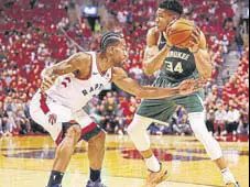  ?? AFP ?? Giannis Antetokoun­mpo (right) of the Milwaukee Bucks handles the ball against Kawhi Leonard of the Toronto Raptors.